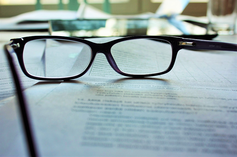 Glasses sitting on paper stock phot